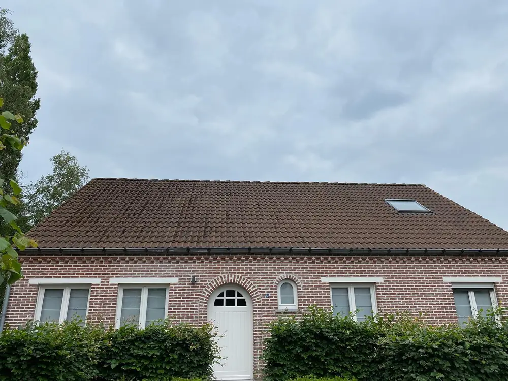 Bakstenen woning met wit geschilderde ramen en voordeur